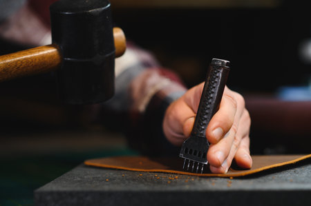 Banner tailor industry craftsman. Leather rolls and tools for handmade craft in workshop.の写真素材
