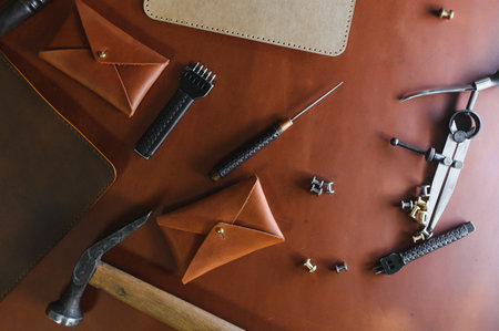 Crafting tools on natural cow leather in the tailoring workshop. Top view.の写真素材