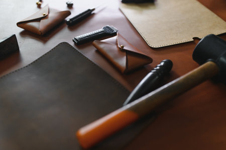 Tools for leather craft on leather backgroung.の写真素材