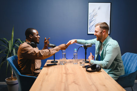 Podcasters shake hands after a good talk. Concept of podcasts and vlogs.