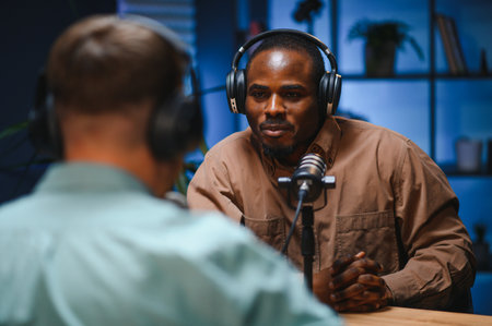 Man recording podcast using high tech microphones to interview guest, ensuring flawless video and sound quality for audience.の写真素材