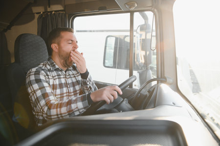 Portrait of tired truck driver feeling sleepy and sick.の写真素材