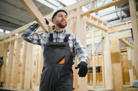 A carpenter works on the construction of modular houses.