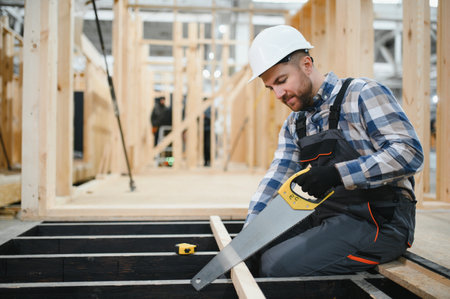 Worker carpenter assembling a modular house.