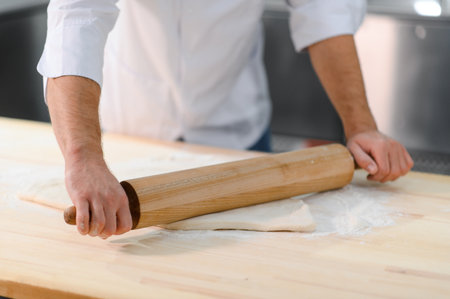 Man preparing pasta on kitchen table.