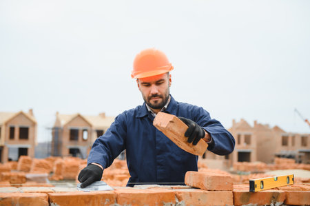 Portrait of a builder in the process of working on a construction site outdoors.の写真素材
