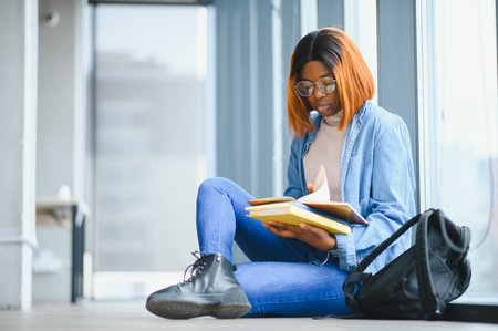 Student studying, exam preparation, distance learning, education concept. Beautiful smiling African American student.の写真素材