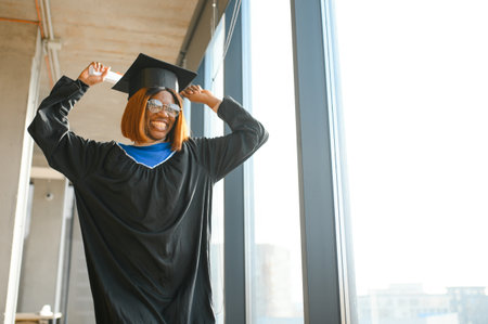 happy African American female student with diploma at graduation.