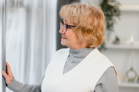 Cheerful pretty older woman in elegant glasses.の写真素材