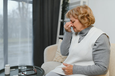 Senior woman suffering from a headache.