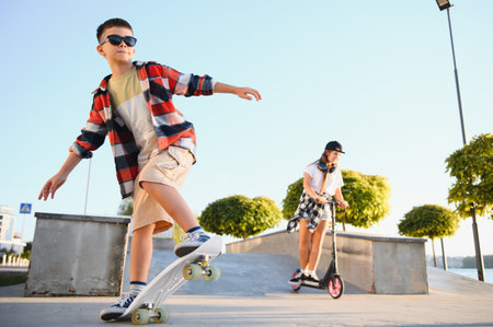 Happy kids having fun at the skate park. Concept of summer holidays and recreation.の写真素材