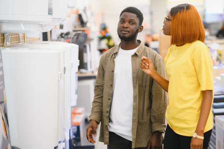 Happy young man and woman buying new heating water boiler.の写真素材
