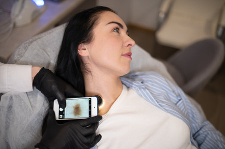 Dermatologist examining moles of patient.