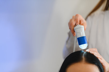 Doctor diagnoses the structure of the hair. Consultation with a trichologist.