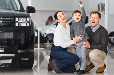 Happy family buying a new car at the car showroom.の写真素材