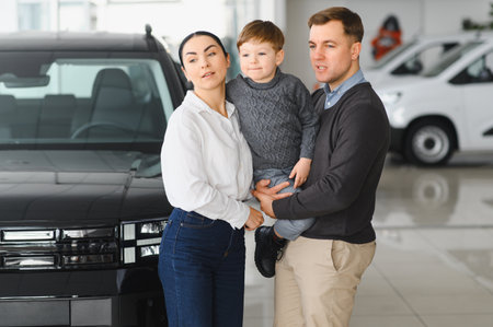 Happy family buying a new car at the car showroom.の写真素材