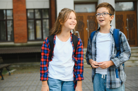 Happy children near the school. Friends boy and girl together in the school yard.の写真素材