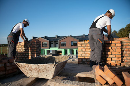 Indian construction workers work on the construction of a brick house. Construction of a brick wall.