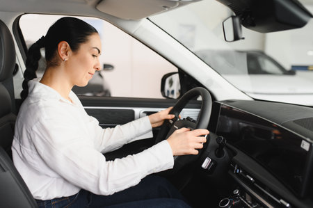 Lady in a car salon. Woman buying the car. In a white shirt.