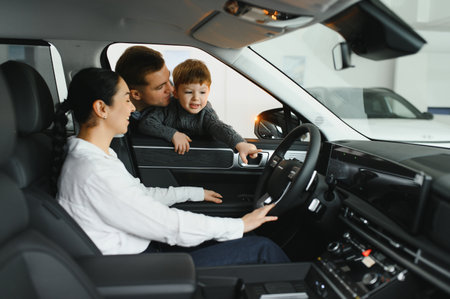 Family in a car dealership. Happy family came to an agreement with a car salesperson at a meeting in...