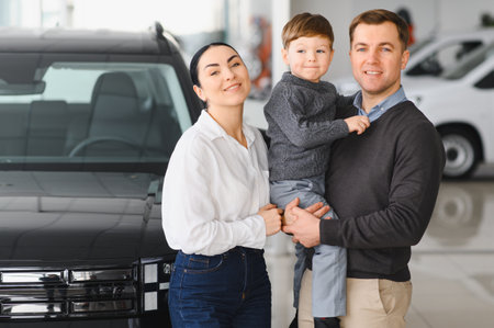 Happy family buying a new car at the car showroom.の写真素材