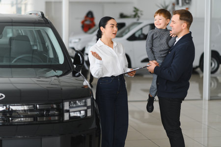 Father and son choosing a new car to buy at the car showroom.の写真素材