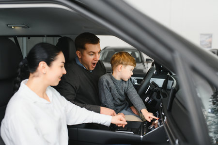 Happy family buying a new car at the car showroom.の写真素材