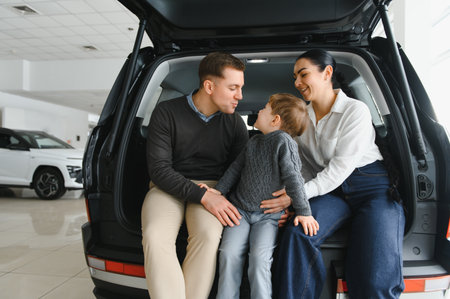 Family in a car dealership. Happy family came to an agreement with a car salesperson at a meeting in...
