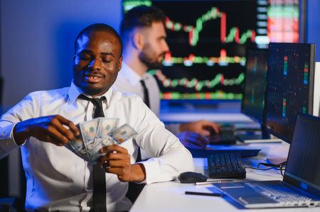 Conception of teamwork. Team of stockbrokers works in modern office with many display screens.