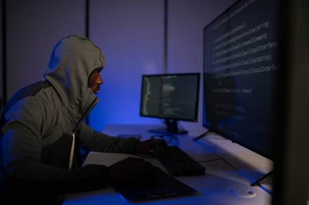 Hacker Using Multiple Computers For Stealing Data On Desk.の写真素材