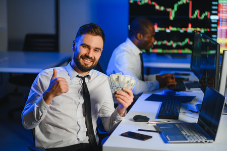 Holding Dollar bills in the stock market. Investor counting money after making it big on the stock market.の写真素材