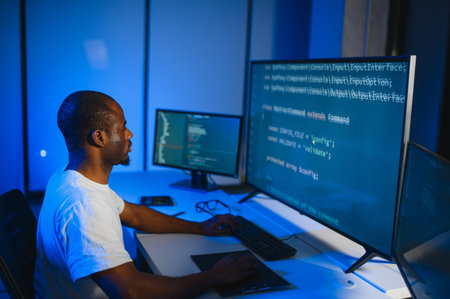 Portrait of African American male programmer in office at night.の写真素材