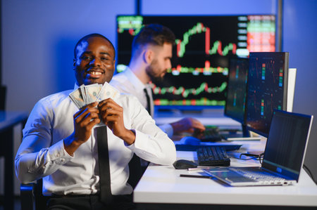 Holding Dollar bills in the stock market. Investor counting money after making it big on the stock market.の写真素材