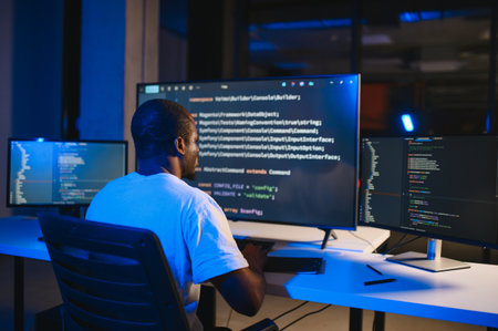 Portrait of African American male programmer in office at night.の写真素材