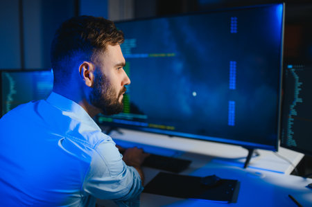Portrait of male programmer in office at night.