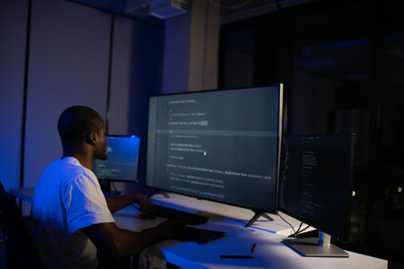 photo of smart skilled introvert tester write typing operating data security evening office dark...