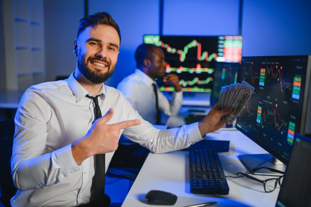 Holding Dollar bills in the stock market. Investor counting money after making it big on the stock market.の写真素材