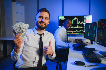 Holding Dollar bills in the stock market. Investor counting money after making it big on the stock market.の写真素材