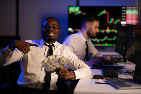 Holding Dollar bills in the stock market. Investor counting money after making it big on the stock market.の写真素材