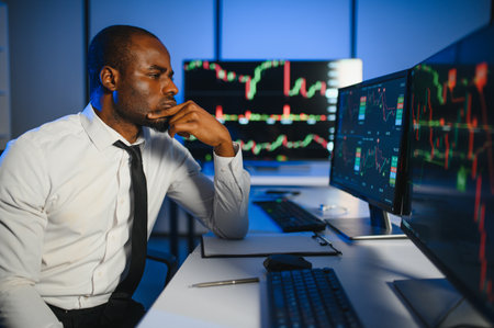 Financial Analyst Working on Computer with Multi-Monitor Workstation with Real-Time Stocks,...