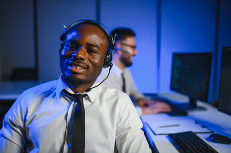 Diverse call center operators team use computers consulting clients in office.の写真素材