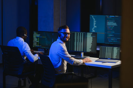 Diverse call center operators team use computers consulting clients in office.
