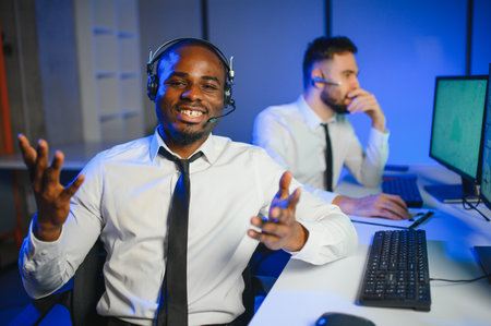 Center of dispatching maintenance. Portrait of men working via headset microphone while sitting on navigation controller board.の写真素材