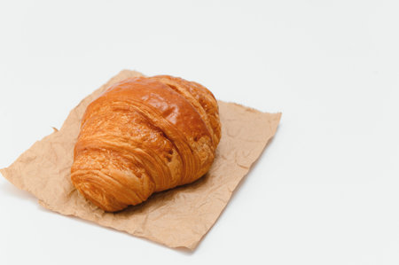 fresh baked croissant isolated on white background.