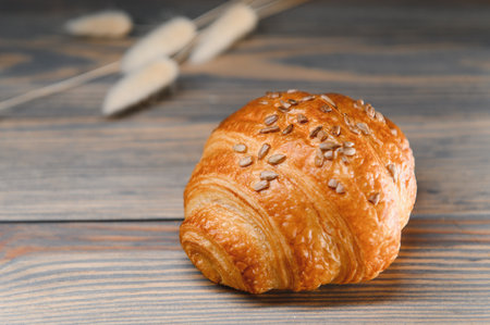 fresh croissant on a wooden background.の写真素材