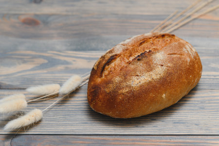 Fresh bread isolated on a wooden background.