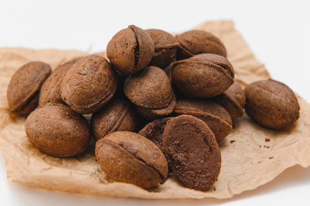 Delicious nut shaped cookies with boiled condensed milk on white background.