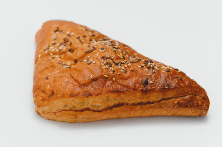 Puff pastry triangle filled with jam on white background.の写真素材