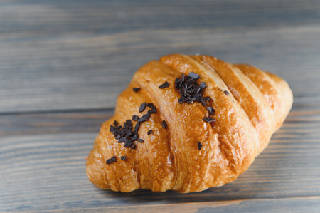 fresh croissant on a wooden background.の写真素材