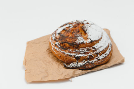 Sweet cinnamon bun roll swirl isolated over the white background.の写真素材